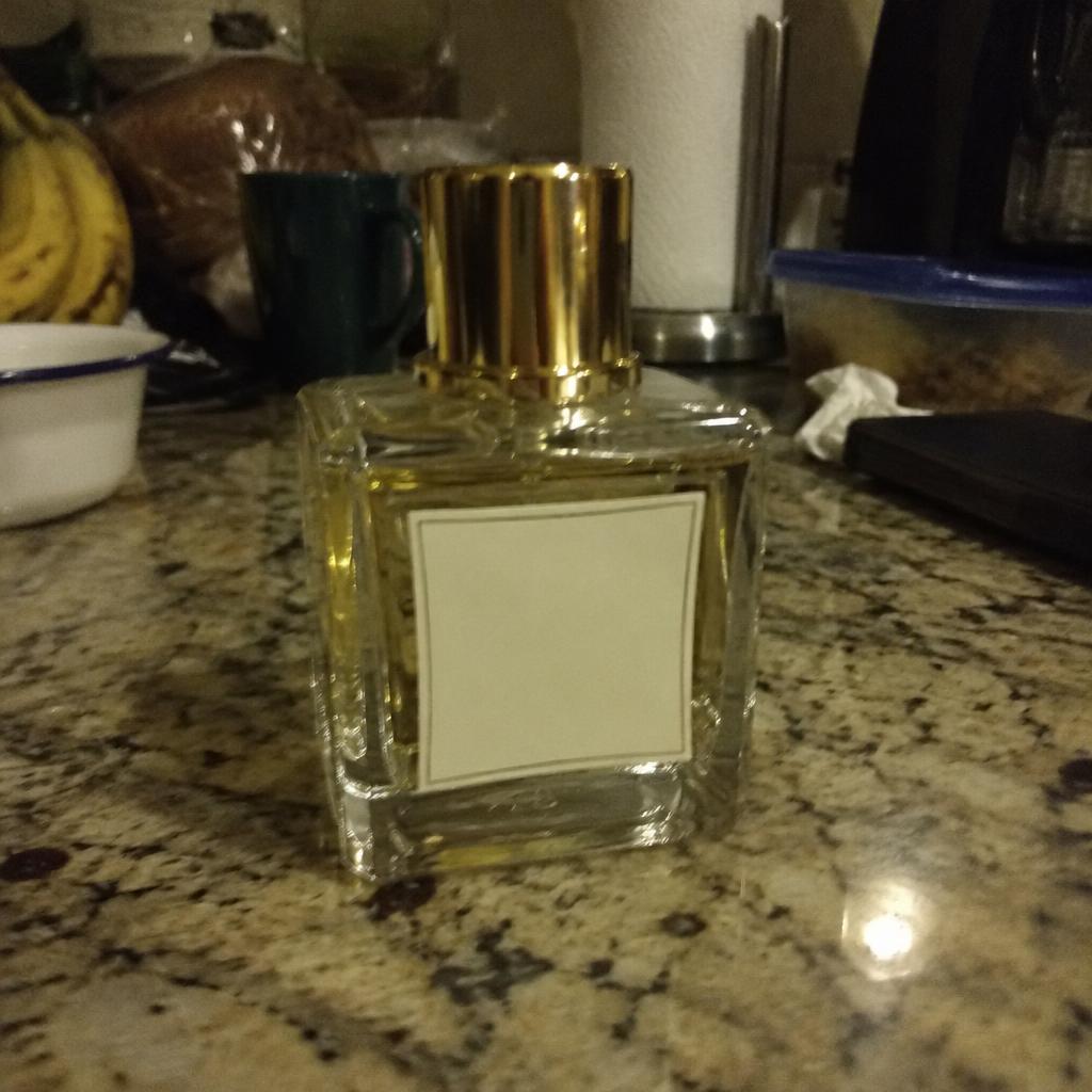 Fragrance bottle photographed on a kitchen counter in ordinary indoor light